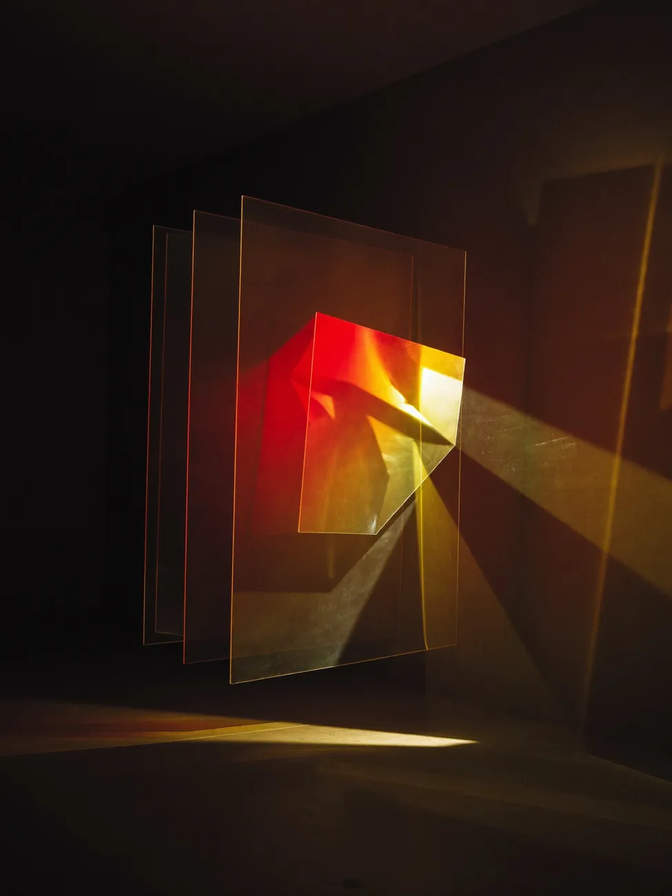 Glowing glass panes catching amber light in a dark room